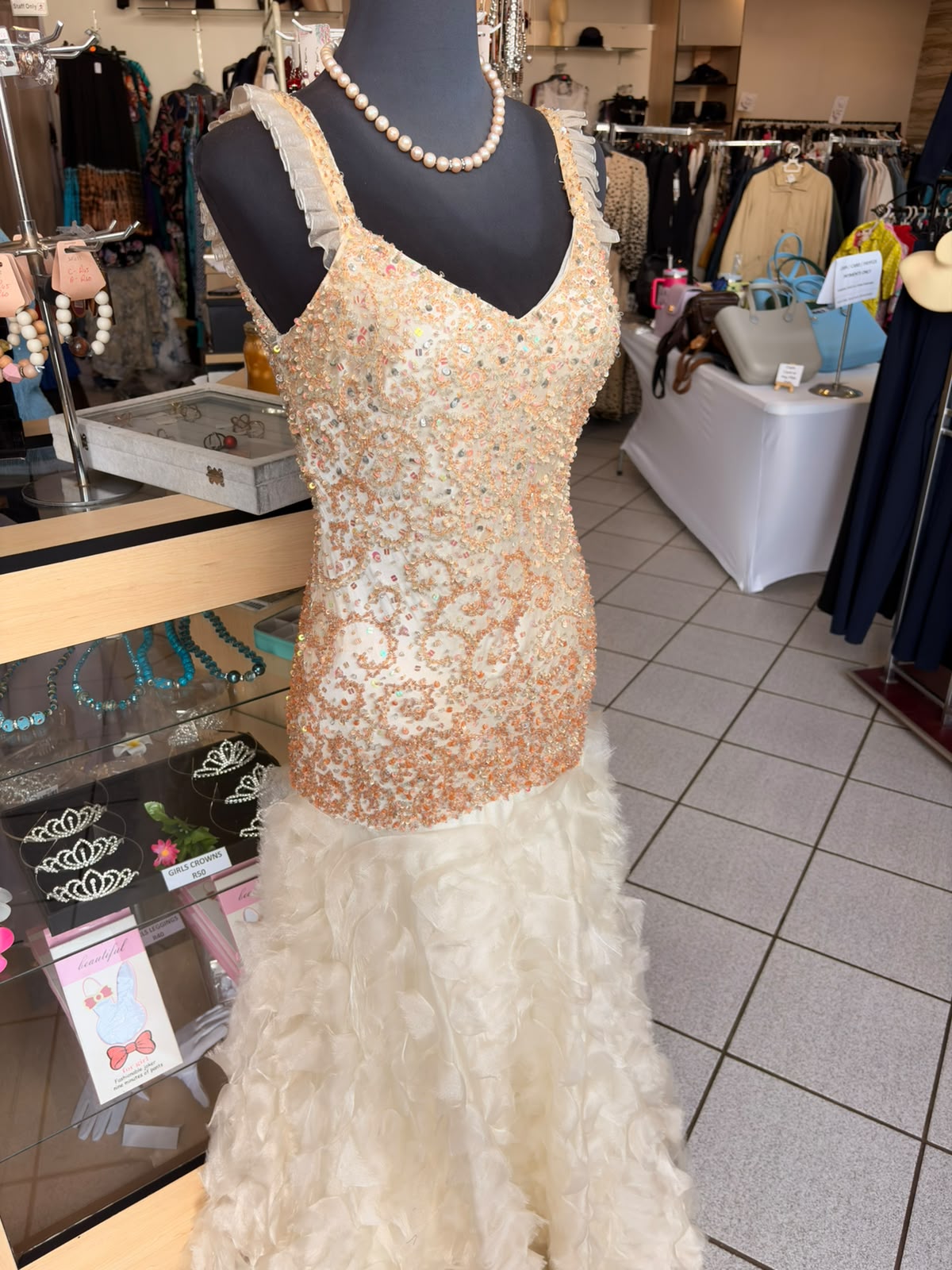 Beaded peach evening gown on a mannequin at Bella Donna boutique in Tzaneen